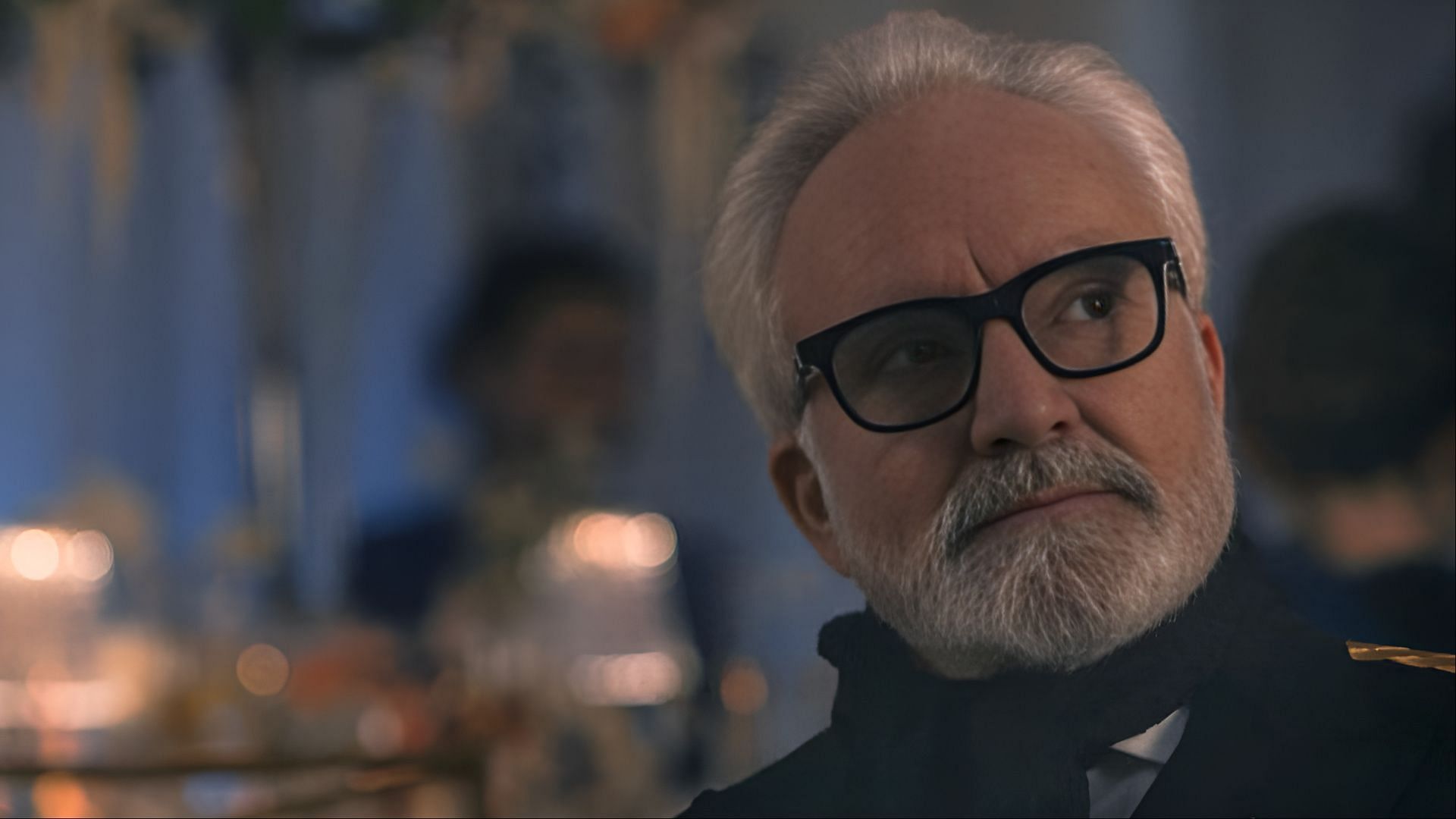 Commander Lawrence listens intently during the tense wedding reception scene in The Handmaid’s Tale season 6 (Image via Hulu)